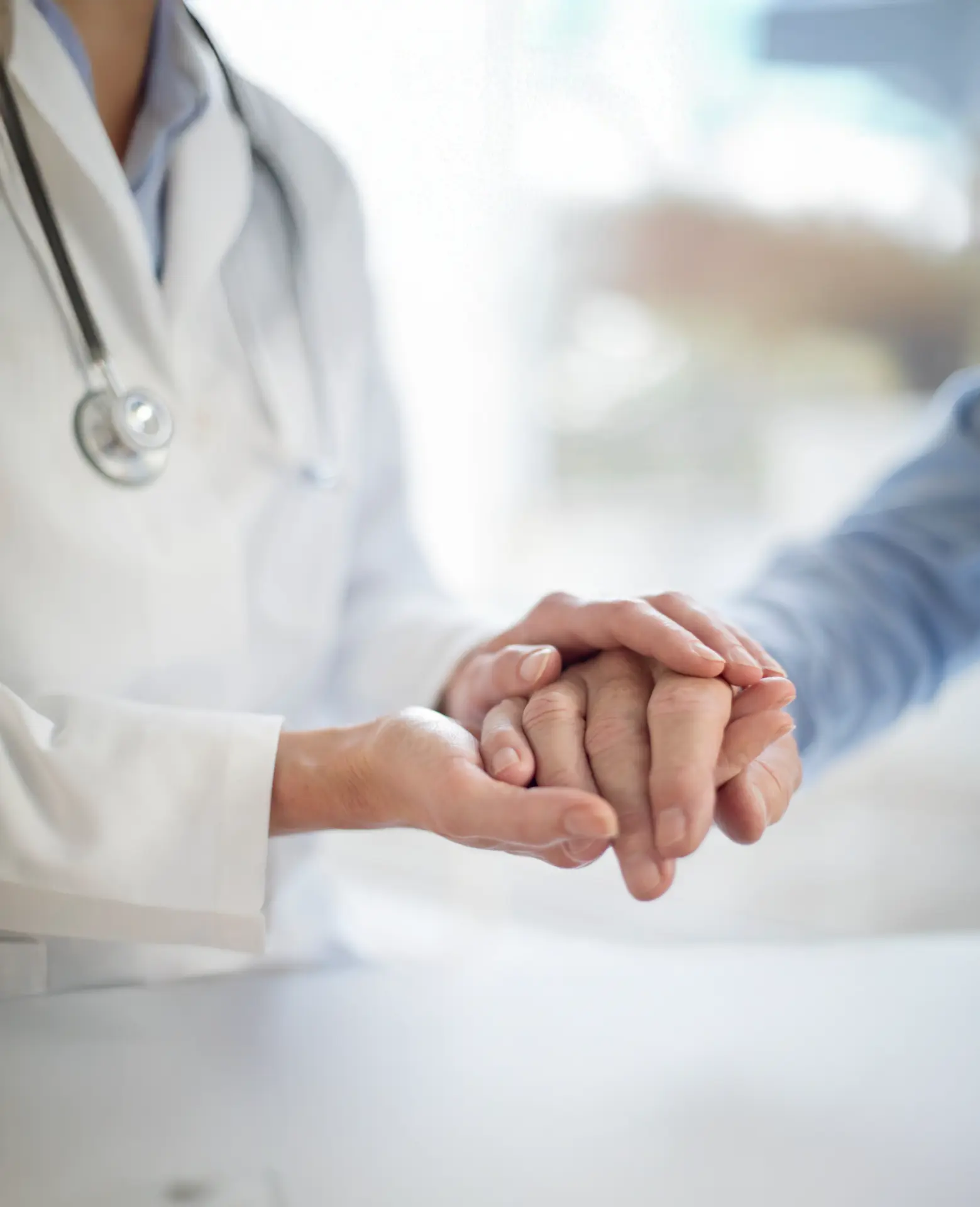 A btt clinician holding a patient's hand with care